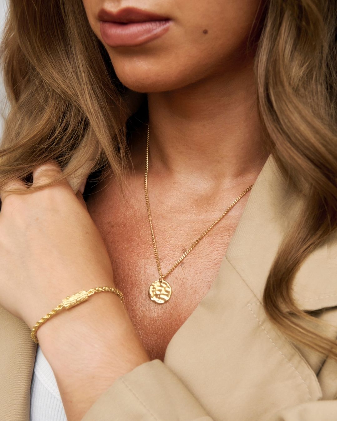 gold pendant being worn