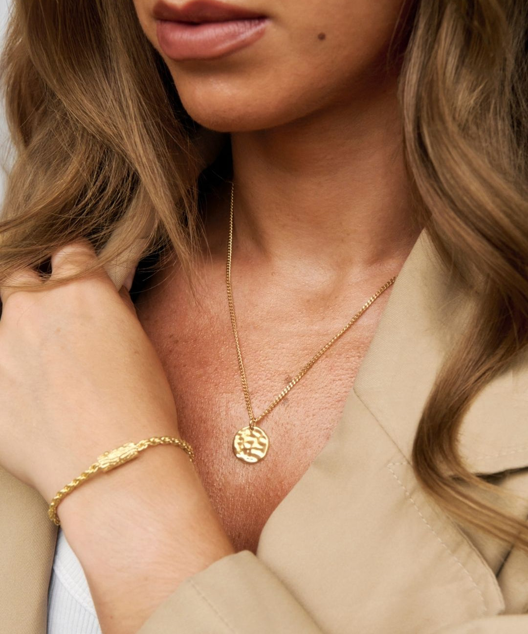 gold pendant being worn